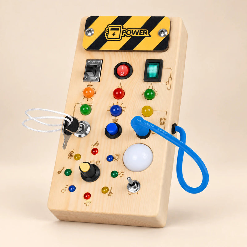 Montessori wooden switch board on a smooth warm beige studio surface, with its original switches, lights, key and blue cord.
