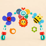 Colourful sensory play arch with a ladybird spinner, patterned flower, smiling sun, bee, hanging rings and two adjustable clamps on a warm beige background.