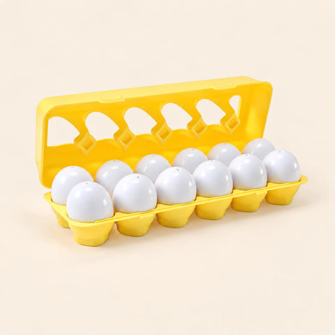 Twelve white shape-sorting eggs in their open yellow case on warm beige.