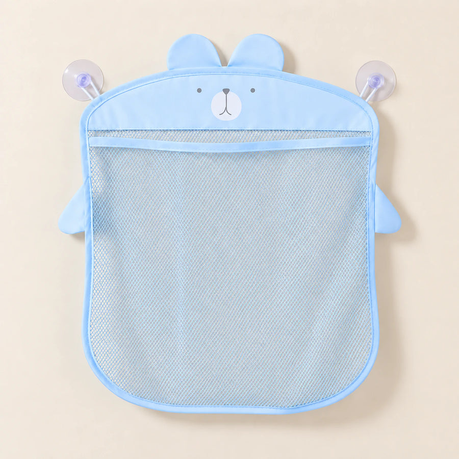 Blue animal-shaped mesh bathroom organizer, empty on warm beige with its two clear suction cups.