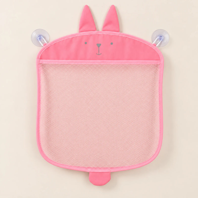 Pink animal-shaped mesh bathroom organizer, empty on warm beige with its two clear suction cups.