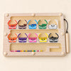 Wooden magnetic sorting board with ten colourful monster cups, beads and an attached wooden stylus on warm beige.