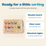Overview of the wooden board with its clear cover, colourful beads and attached magnetic stylus.