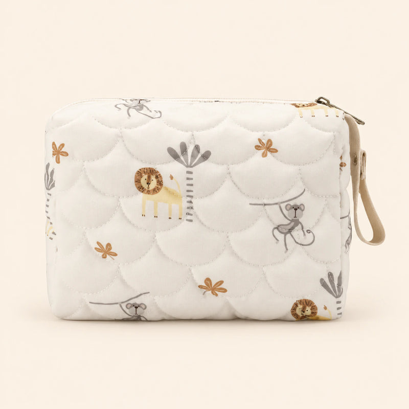 Cream quilted zip pouch with animal print, top zipper and snap wrist loop, on warm beige.