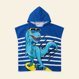 Sunny Bloom hooded beach poncho with its original blue dinosaur print on a warm beige background.