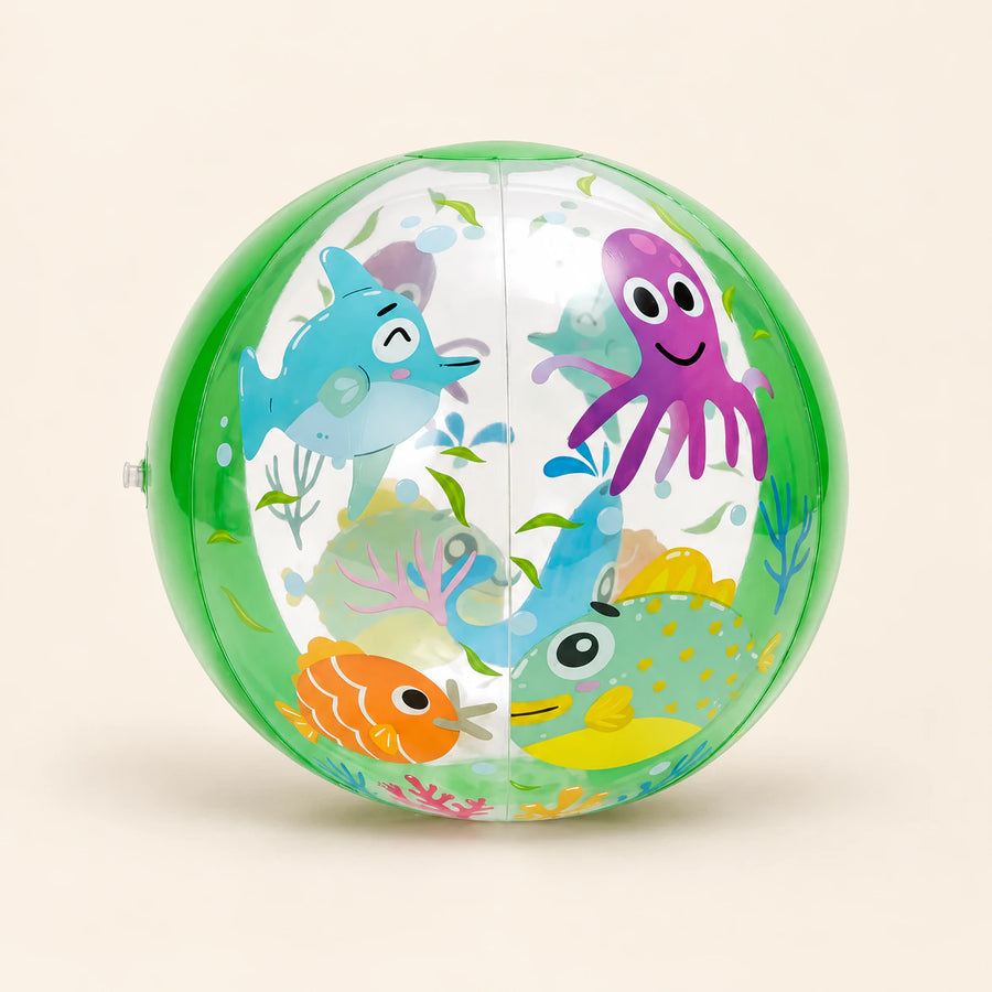 Green transparent inflatable ball with shark, octopus and fish prints on a warm beige background.