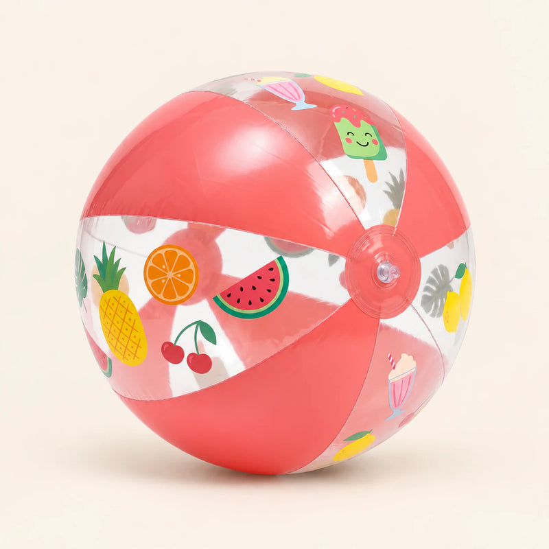 Coral-pink inflatable ball with clear fruit-print panels and a front-facing valve on a warm beige background.
