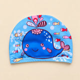 Blue whale fabric swim cap with small colourful fish and a stitched lower hem.