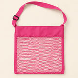 Pink Cloud Plush mesh beach bag shown empty, with matching adjustable shoulder strap and black slider on smooth pale warm beige.