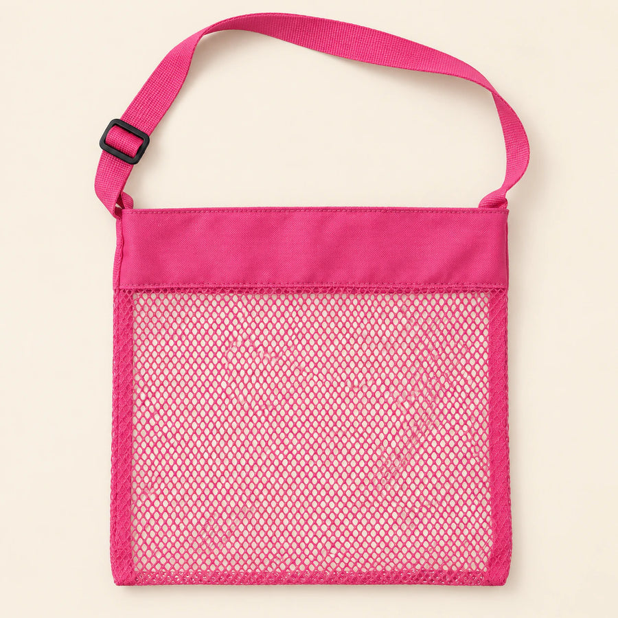 Pink Cloud Plush mesh beach bag shown empty, with matching adjustable shoulder strap and black slider on smooth pale warm beige.