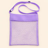 Purple Splash mesh beach bag shown empty, with matching adjustable shoulder strap and black slider on smooth pale warm beige.