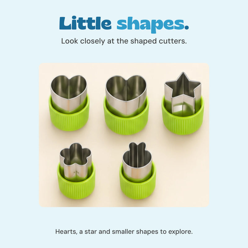 Close view of the five green handled metal shape cutters, including hearts and a star.
