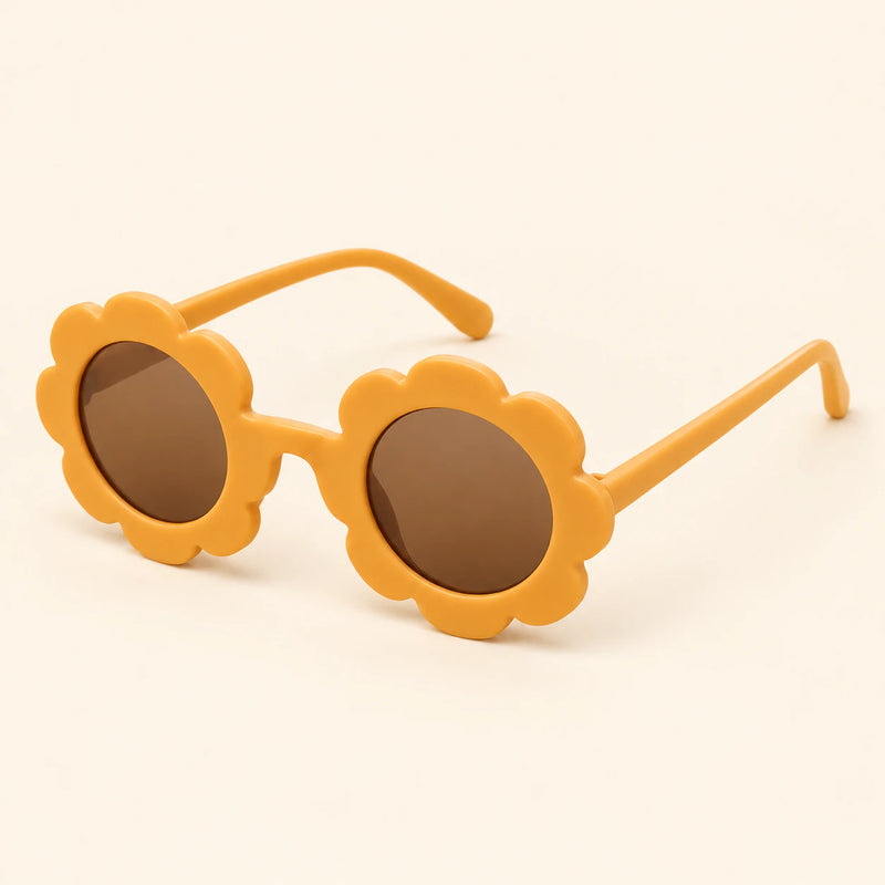 One pair of flower-shaped sunglasses with round brown lenses in the Orange colour on a warm beige background.