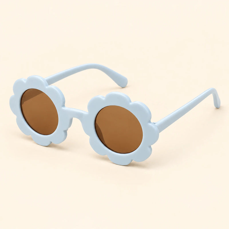 One pair of flower-shaped sunglasses with round brown lenses in the Blue colour on a warm beige background.