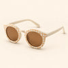 Cream Checker Sun Shades with the original frame pattern, open arms and brown lenses on warm beige.