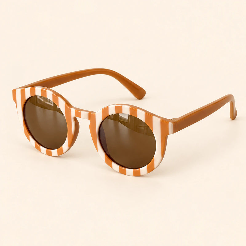 Orange Checker Sun Shades with the original frame pattern, open arms and brown lenses on warm beige.