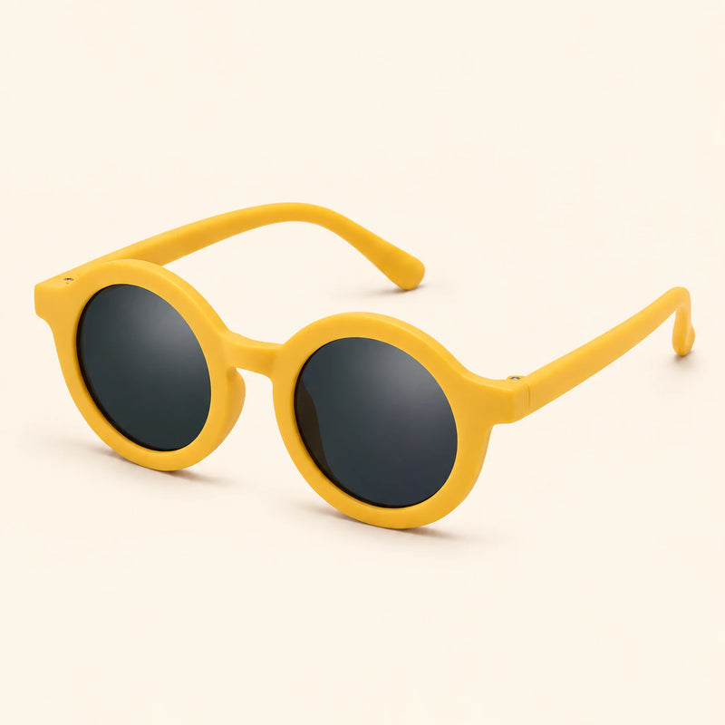 One pair of round sunglasses in the Yellow Honey Bee option on a warm beige background.