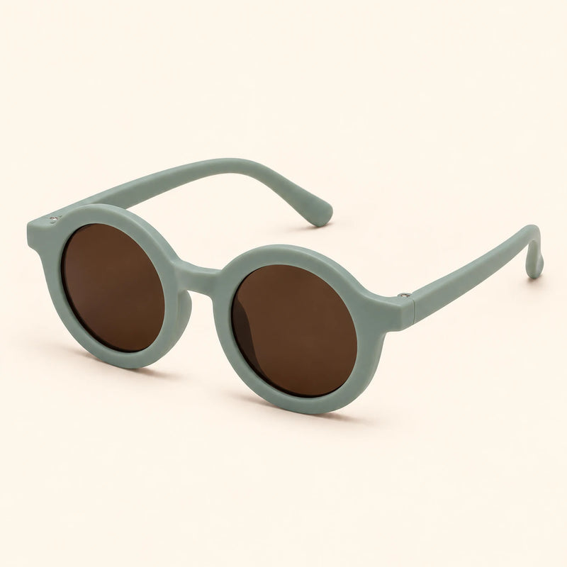 One pair of round sunglasses in the Sage Green option on a warm beige background.
