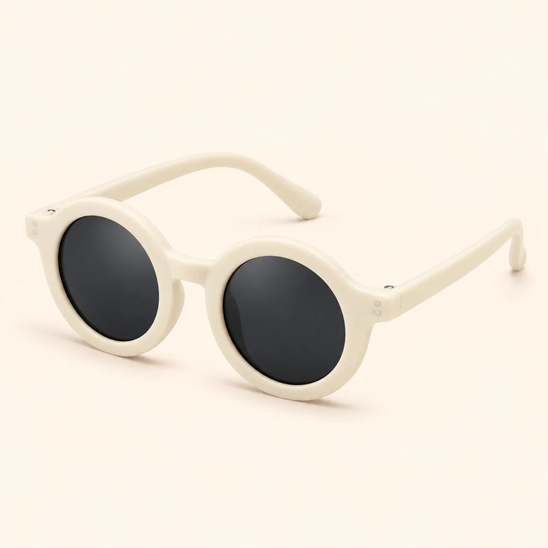 One pair of round sunglasses in the Cream White option on a warm beige background.