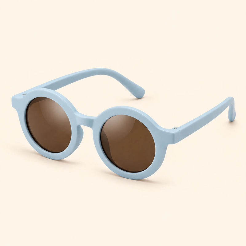 One pair of round sunglasses in the Sky Blue option on a warm beige background.