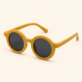 One pair of mustard-coloured round sunglasses in the live Cloud Cream option on a warm beige background.