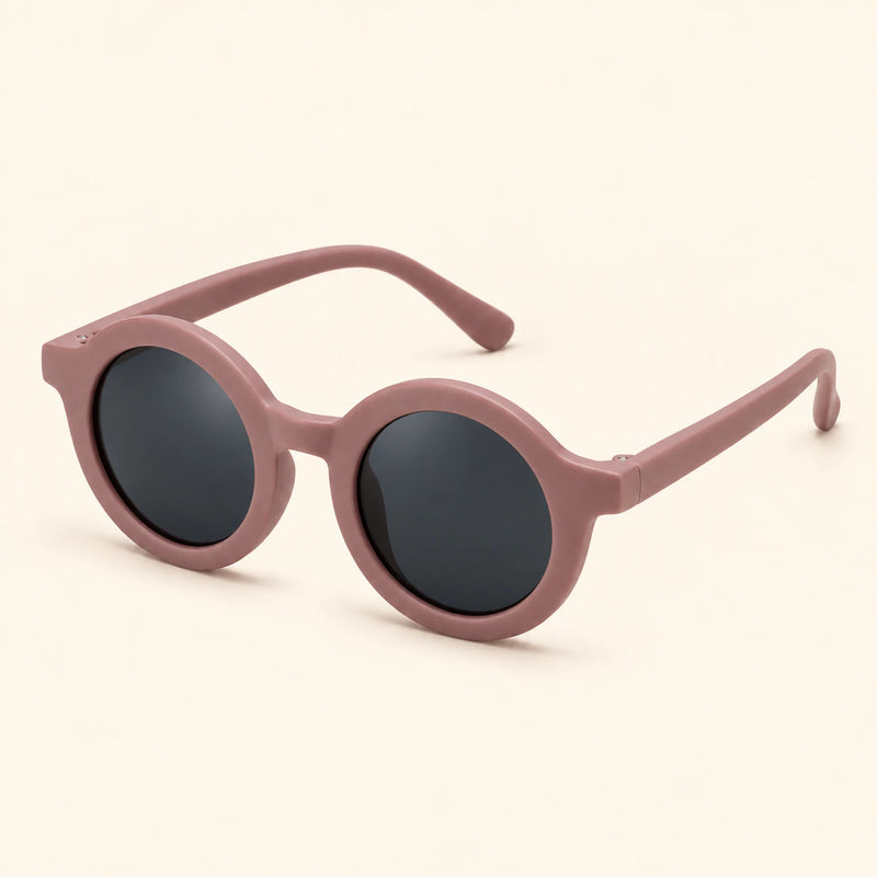One pair of round sunglasses in the Dusty Rose option on a warm beige background.