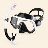 A mask and separate matching snorkel in the White option on a warm beige background.
