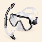 A mask and separate matching snorkel in the Clear option on a warm beige background.
