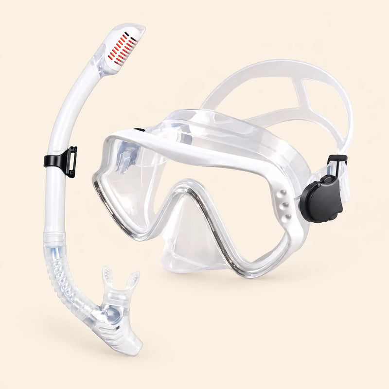 A mask and separate matching snorkel in the Clear White option on a warm beige background.