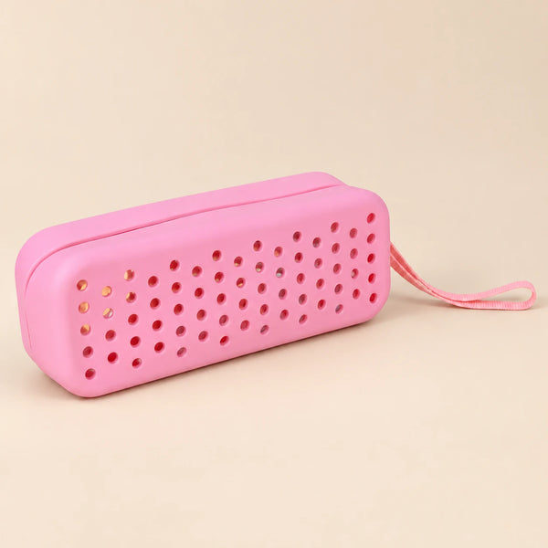 Mermaid Pink goggle case with ventilation holes and matching carry loop on a smooth warm beige background.