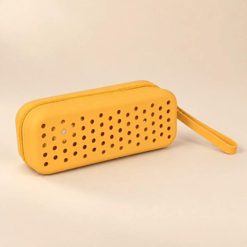 Yellow Honey Bee goggle case with ventilation holes and matching carry loop on a smooth warm beige background.