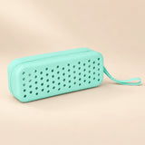 Ocean Friends goggle case with ventilation holes and matching carry loop on a smooth warm beige background.