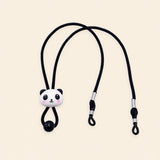 Black cord with panda charm, sliding bead and two adjustable black end loops on a warm beige background.