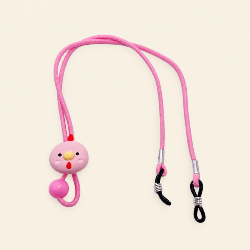 Pink cord with chicken charm, sliding bead and two adjustable black end loops on a warm beige background.