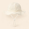 TibaToes™ CloudShade Hat, Cloud Cream option on a clean warm beige background.