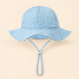 TibaToes™ CloudShade Hat, Sky Blue option on a clean warm beige background.