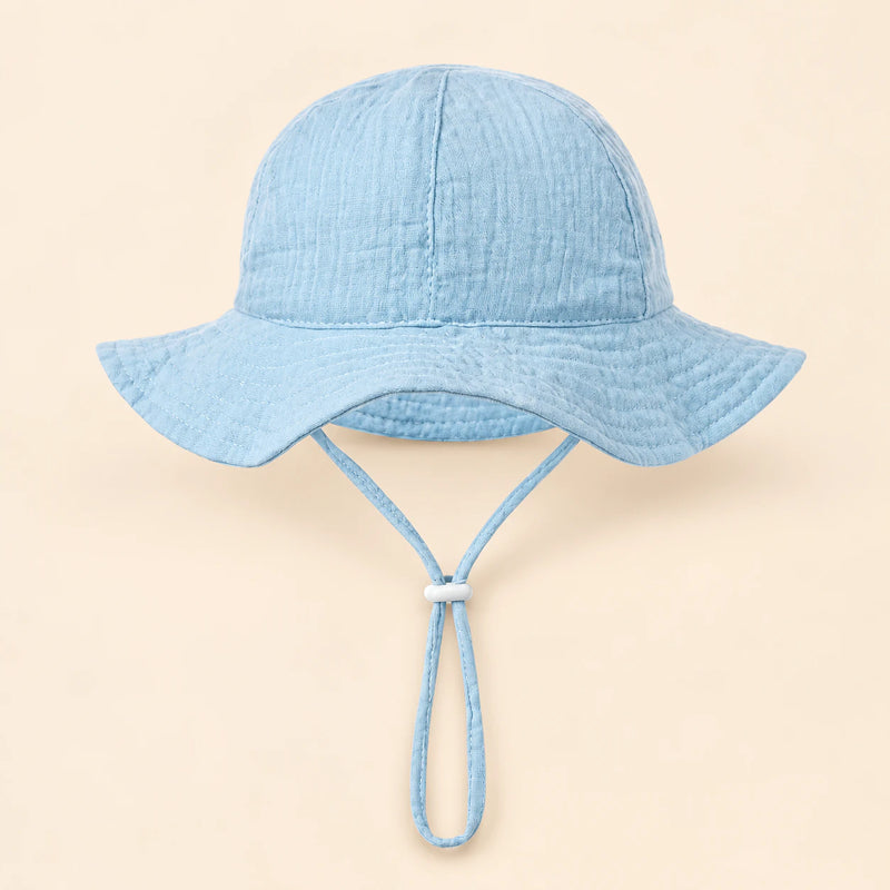 TibaToes™ CloudShade Hat, Sky Blue option on a clean warm beige background.