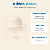 Cream CloudShade hat with descriptions of its flexible stitched brim, adjustable cord and cotton texture.