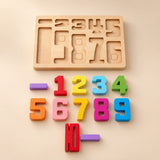 Colourful wooden number blocks and two purple bars arranged below their wooden storage tray in warm daylight.