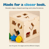 Close detail of the natural wood grain, fitted lid and shaped openings of the sorting cube.