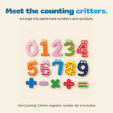 Ten colourful magnetic numbers with character faces and five arithmetic symbols arranged on beige.