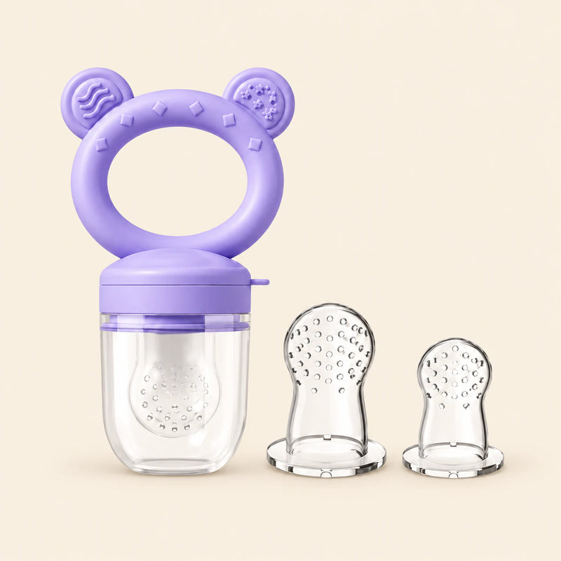 Lavender Feeder + Tips showing the ring-handled feeder, clear cover, two extra perforated tips on warm beige.