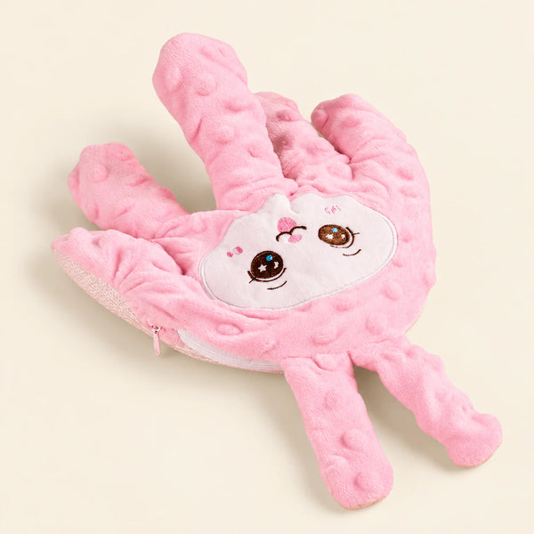 Blush hand-shaped plush pillow with its original embroidered character face and raised-dot fabric, alone on warm beige.