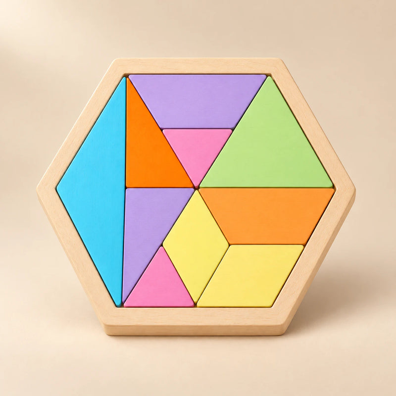A hexagonal wooden board with large pastel geometric pieces on a sunlit beige tabletop.