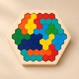 A wooden hexagonal tray with bright grouped hexagon patterns on a softly lit warm beige studio surface.