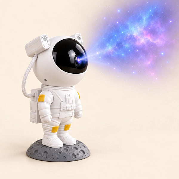 White astronaut galaxy night light projector on an oak bedside table with its blue and violet nebula effect visible on the textured wall.