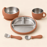Chestnut Dine Set with empty three-section stainless steel plate, bowl, single-handled cup, spoon and fork on warm beige.