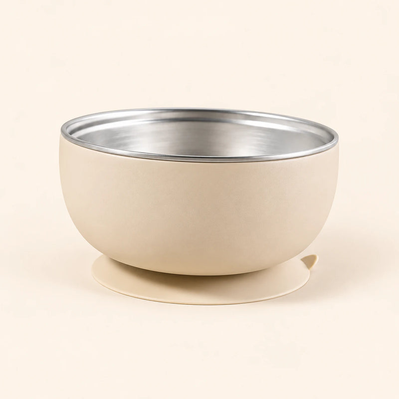 Oat Bear Bowl with a stainless steel interior and round suction base, shown empty on warm beige.