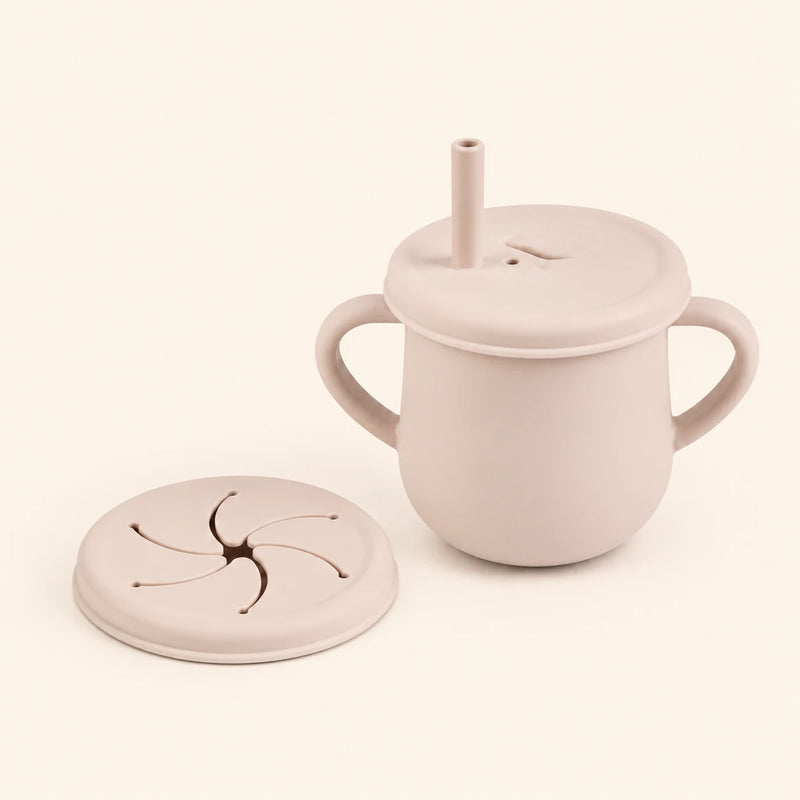 Oat Beige silicone cup with two side handles, fitted straw lid and straw, plus a separate snack lid on warm beige.