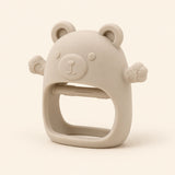 Oat bear teether with raised face, rounded ears, side paws and open-centre grip on warm beige.